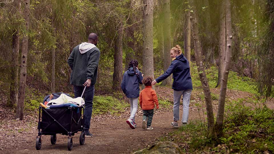 Fotograf: Maskot
Bildbyrå: Johnér Familj med två barn promenerar i skogen och drar en campingvagn efter sig. Sverige